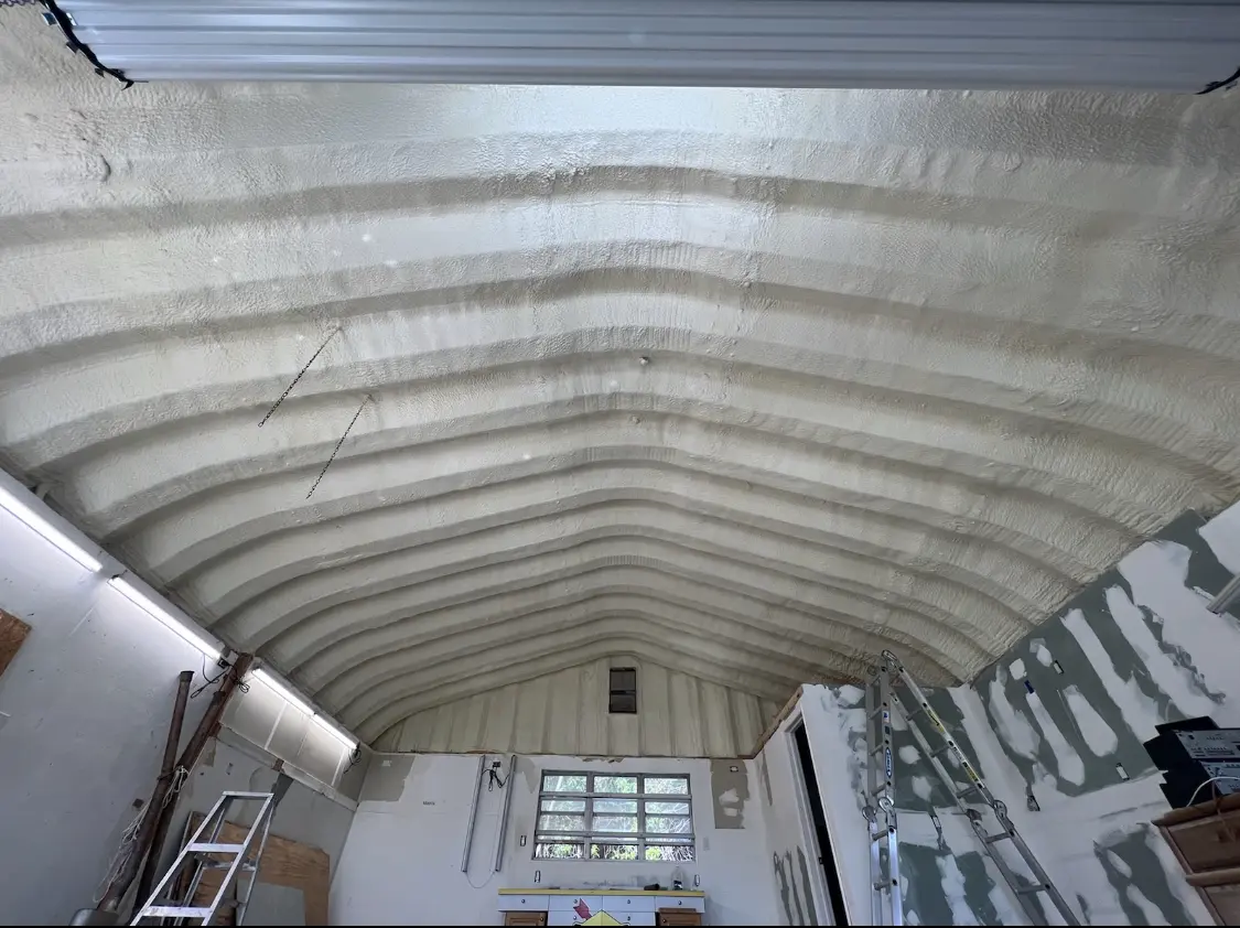 Spray polyurethane foam applied to the underside of a metal roof deck in Starke